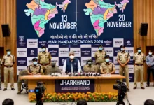 DALL·E 2024 10 16 00.46.27 A press conference scene in Ranchi Jharkhand with the states Chief Electoral Officer K. Ravi Kumar addressing the media. The backdrop features bann